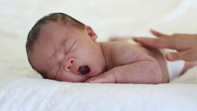 Should your baby sleep on their tummy or back?