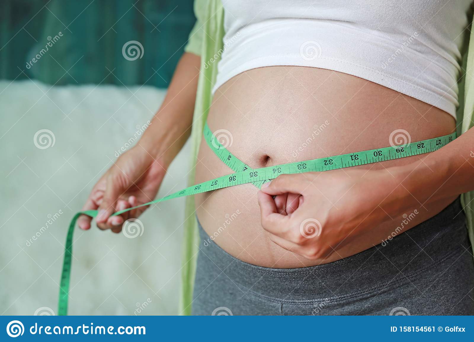 Pregnant Woman Measuring Her Belly With Tape Measure Stock Image ...